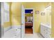 Bright bathroom features white bathtub and a view to the bedroom at 808 Arbor Ln., North Myrtle Beach, SC 29582