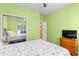 This bedroom features bright green walls and an adjacent bedroom with a mirrored closet door at 808 Arbor Ln., North Myrtle Beach, SC 29582