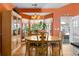 Bright dining room features hardwood floors, bay windows, and a charming wooden table set at 808 Arbor Ln., North Myrtle Beach, SC 29582
