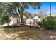 Charming home with meticulous landscaping, mature trees, and an inviting outdoor seating area at 808 Arbor Ln., North Myrtle Beach, SC 29582