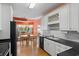 Bright kitchen with white cabinets, black countertops, and stainless steel appliances, adjacent to dining area at 808 Arbor Ln., North Myrtle Beach, SC 29582