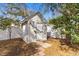 Exterior view of a garden shed on a brick foundation, enclosed within a fenced yard with mature trees at 808 Arbor Ln., North Myrtle Beach, SC 29582