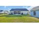 View of screened porch in large back yard with black fence at 124 Mesa Raven Dr., Longs, SC 29568