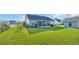 Manicured backyard and screened porch with fence enclosing backyard at 124 Mesa Raven Dr., Longs, SC 29568