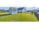 Spacious backyard featuring lush green grass, a storage shed, and a secure black fence at 124 Mesa Raven Dr., Longs, SC 29568