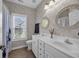 Bright bathroom with a double vanity, decorative mirrors, and stylish wallpaper at 124 Mesa Raven Dr., Longs, SC 29568