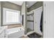 Bathroom featuring soaking tub, shower and window, complete with modern design at 124 Mesa Raven Dr., Longs, SC 29568