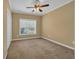 Spacious bedroom with a ceiling fan and window, offering ample natural light and closet at 124 Mesa Raven Dr., Longs, SC 29568