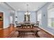 Cozy dining room featuring a rustic table, chandelier, and plenty of seating at 124 Mesa Raven Dr., Longs, SC 29568