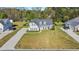Stunning exterior view of a two-story home with a landscaped yard and a welcoming front porch at 124 Mesa Raven Dr., Longs, SC 29568