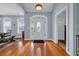 Elegant foyer with hardwood floors, a decorative door, and ample natural light at 124 Mesa Raven Dr., Longs, SC 29568