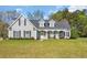Charming home with a covered front porch, dark shutters, and manicured landscaping at 124 Mesa Raven Dr., Longs, SC 29568