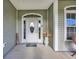 Inviting front porch featuring a decorative door with a welcome mat and stylish decor at 124 Mesa Raven Dr., Longs, SC 29568