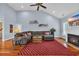 Inviting living room with a fireplace, large sectional sofa, and abundant natural light at 124 Mesa Raven Dr., Longs, SC 29568