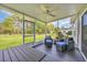 Relaxing screened porch with furniture and view of the backyard at 124 Mesa Raven Dr., Longs, SC 29568