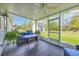 Screened porch with patio furniture and fan overlooking backyard at 124 Mesa Raven Dr., Longs, SC 29568