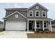 Charming two-story home with a two-car garage and inviting front porch at 1304 Winding Creek Way, Myrtle Beach, SC 29588
