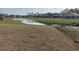 Scenic view of a pond surrounded by lush greenery in a peaceful community at 1304 Winding Creek Way, Myrtle Beach, SC 29588