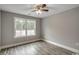 A well-lit bedroom with wood-look flooring and a large window at 1395 Knotty Branch Rd., Conway, SC 29527
