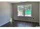 Bright bedroom featuring a window overlooking a verdant scene and sleek wood-look flooring at 1395 Knotty Branch Rd., Conway, SC 29527