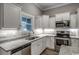 This kitchen boasts white cabinets, granite countertops, stainless steel appliances, and a window at 1395 Knotty Branch Rd., Conway, SC 29527