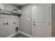 A well-lit laundry area features gray walls, a wire shelf, and modern hookups at 1395 Knotty Branch Rd., Conway, SC 29527