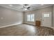 Bright living room boasts a ceiling fan, wood-look flooring and a window for plenty of natural light at 1395 Knotty Branch Rd., Conway, SC 29527