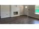 Bright living room featuring a fireplace, white trim and molding, and wood-look floors at 1395 Knotty Branch Rd., Conway, SC 29527