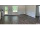 Living room features wood-look flooring, custom trim, and natural light at 1395 Knotty Branch Rd., Conway, SC 29527