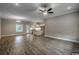 Spacious living room features wood-look flooring, ceiling fan, and open access to the kitchen at 1395 Knotty Branch Rd., Conway, SC 29527