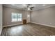 Open living room features wood-look flooring, a ceiling fan, and a door leading to the outside at 1395 Knotty Branch Rd., Conway, SC 29527