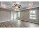 Spacious main bedroom with tray ceiling, ceiling fan, and light gray walls at 1395 Knotty Branch Rd., Conway, SC 29527