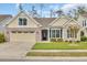 Charming brick home with a manicured lawn, attached garage, and inviting front entrance at 1478 Suncrest Dr., Myrtle Beach, SC 29577