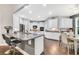 Modern kitchen with white cabinets, island with seating, and stainless steel appliances at 1478 Suncrest Dr., Myrtle Beach, SC 29577