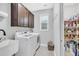 Well-lit laundry room includes a washer, dryer, sink, storage cabinets, and pantry at 1478 Suncrest Dr., Myrtle Beach, SC 29577