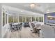 Bright sunroom featuring lots of windows, a ceiling fan and comfortable seating at 1478 Suncrest Dr., Myrtle Beach, SC 29577
