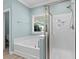 Bathroom featuring separate soaking tub and shower with tile surround and a window at 152 Shenandoah Dr., Murrells Inlet, SC 29576