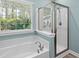 Bright bathroom featuring a soaking tub, a glass enclosed shower, and a window at 152 Shenandoah Dr., Murrells Inlet, SC 29576