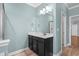 Bathroom vanity with black cabinets, an expansive mirror, and modern lighting at 152 Shenandoah Dr., Murrells Inlet, SC 29576