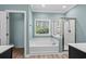 Bright bathroom with a separate tub, glass shower and light blue walls at 152 Shenandoah Dr., Murrells Inlet, SC 29576