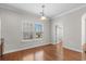 Bright dining room featuring hardwood floors, chair railing, and a modern light fixture at 152 Shenandoah Dr., Murrells Inlet, SC 29576