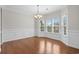 Dining room with large windows, chair railing, hardwood floors, and modern chandelier at 152 Shenandoah Dr., Murrells Inlet, SC 29576