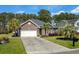 Charming brick home with attached garage, well-maintained lawn, and palm tree landscaping at 152 Shenandoah Dr., Murrells Inlet, SC 29576