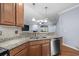 Kitchen sink area showcasing granite counters and an open view into the living room at 152 Shenandoah Dr., Murrells Inlet, SC 29576
