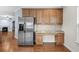 A stainless steel refrigerator is next to custom wood cabinets with granite counters and modern appliances at 152 Shenandoah Dr., Murrells Inlet, SC 29576