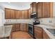 Kitchen featuring wooden cabinets, granite countertops, stainless steel appliances, and tile backsplash at 152 Shenandoah Dr., Murrells Inlet, SC 29576