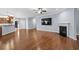 Open-concept living room with hardwood flooring, fireplace, and open access to kitchen at 152 Shenandoah Dr., Murrells Inlet, SC 29576