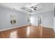 Spacious primary bedroom featuring a tray ceiling, two windows and hardwood floors at 152 Shenandoah Dr., Murrells Inlet, SC 29576