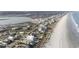 Stunning aerial view of oceanfront homes, a pristine beach, and scenic waterways at 1581 S Waccamaw Dr. # 303, Murrells Inlet, SC 29576