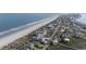 Aerial view of a coastal community showcasing beachfront homes and the Waterforde condo complex at 1581 S Waccamaw Dr. # 303, Murrells Inlet, SC 29576